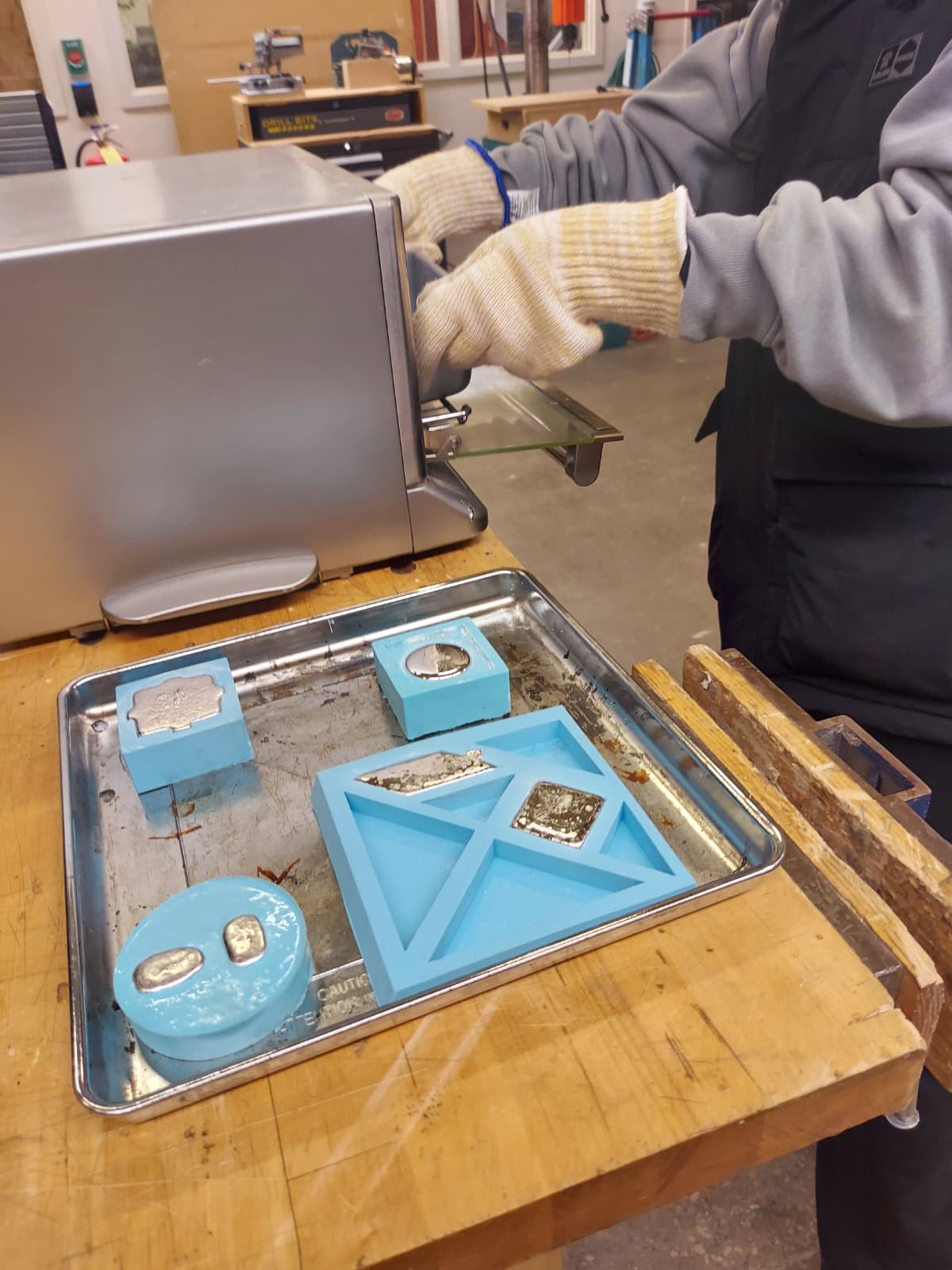 Tray with silicone molds filled with molten metal